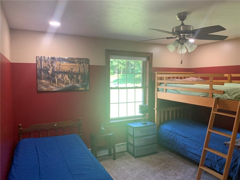 1213 Sunol Road Cochranton, PA 16314 - Photo 23 of 25 a bedroom with a bed and a chandelier