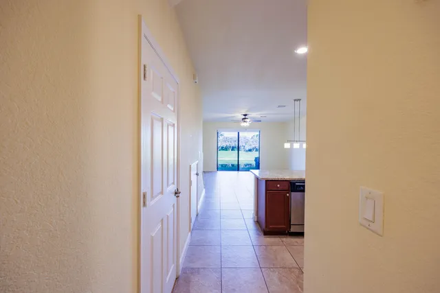 a view of a hallway with wooden floor and windows