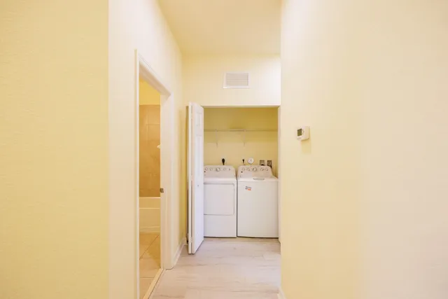 a view of a bathroom with a shower and a sink