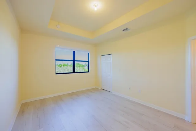 a view of a room with wooden floor and window