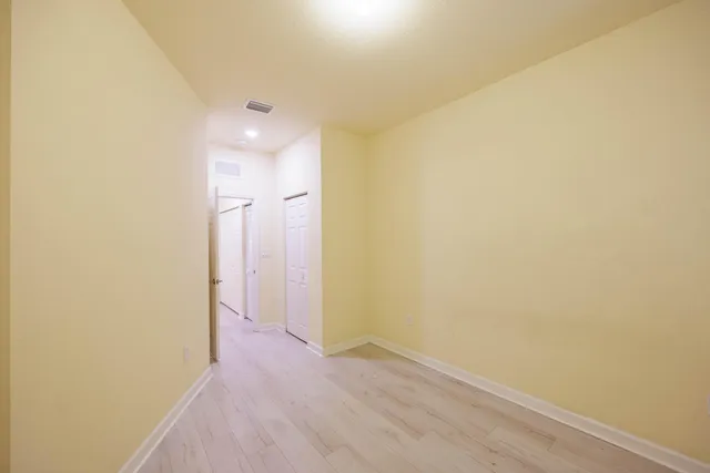 a view of a room with wooden floor