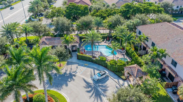 an aerial view of a house yard swimming pool and outdoor seating