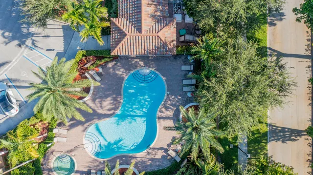 an aerial view of a house with a yard and garden