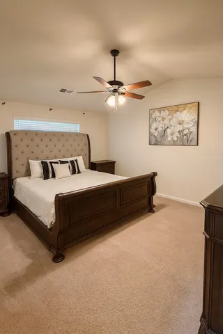 a bedroom with a bed and a ceiling fan
