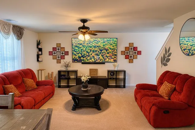 a living room with furniture a rug and a window