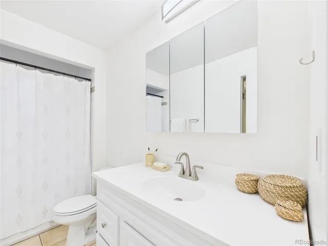 a bathroom with a sink toilet and mirror