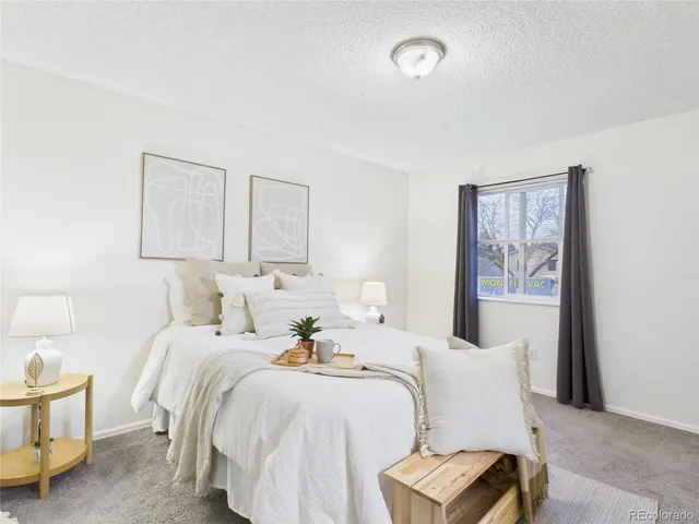 a bedroom with a bed and a couch