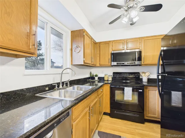 a kitchen with a sink stove top oven and microwave