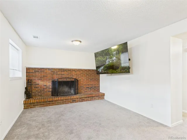 a view of an empty room with a fireplace