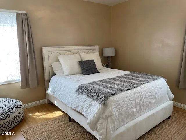 a bedroom with a bed and window
