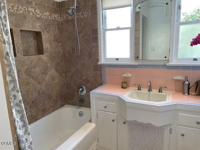a bathroom with a sink toilet vanity and tub