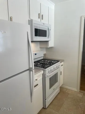 a stove top oven sitting inside of a kitchen