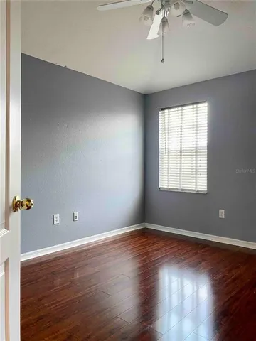 a view of room with wooden floor and fan