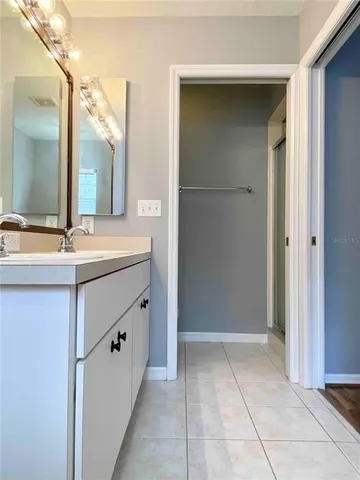 a bathroom with a tub sink and mirror