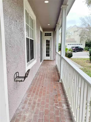 a view of porch with a floor to ceiling windows