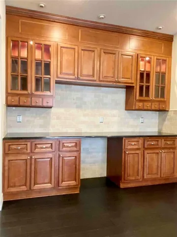 a kitchen with stainless steel appliances granite countertop a stove and a white cabinets