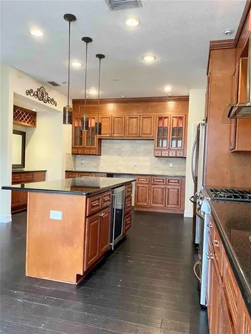 a kitchen with stainless steel appliances granite countertop a stove a sink and a refrigerator