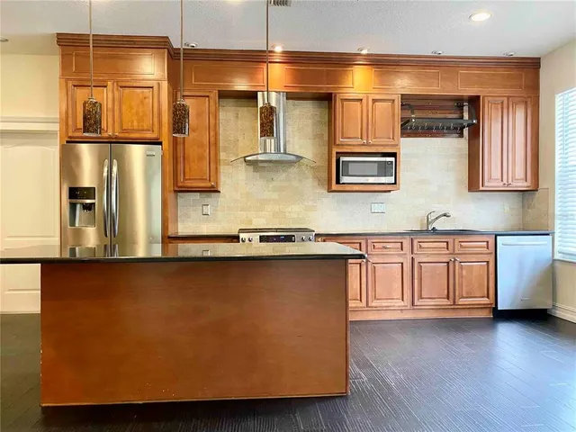 a kitchen with stainless steel appliances a refrigerator and stove