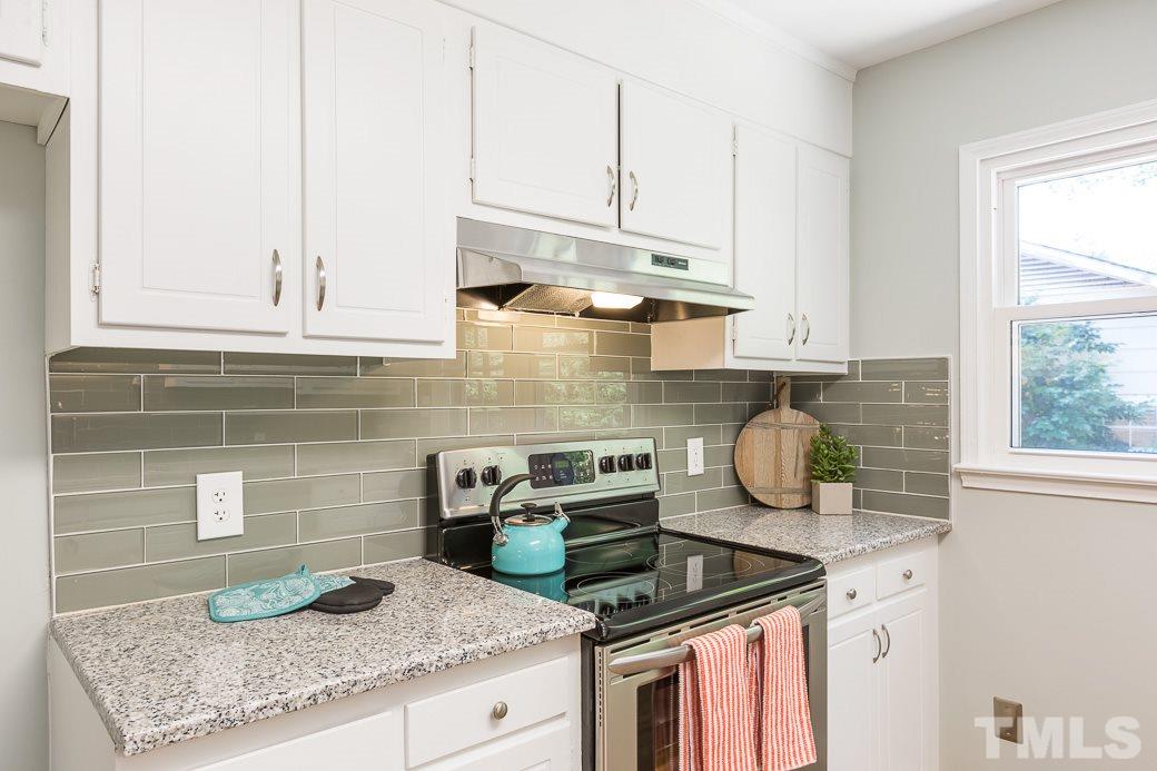 400 Old Farm Road Raleigh, NC 27606 - Photo 11 of 23 Bright kitchen offering freshly painted cabinets & new granite counter tops w/ lots of task space & storage.New glass subway tile back splash, double-bowl stainless sink w/Hansgrohe faucet, new lighting fixtures, new stainless appliances. New site-laid HW
