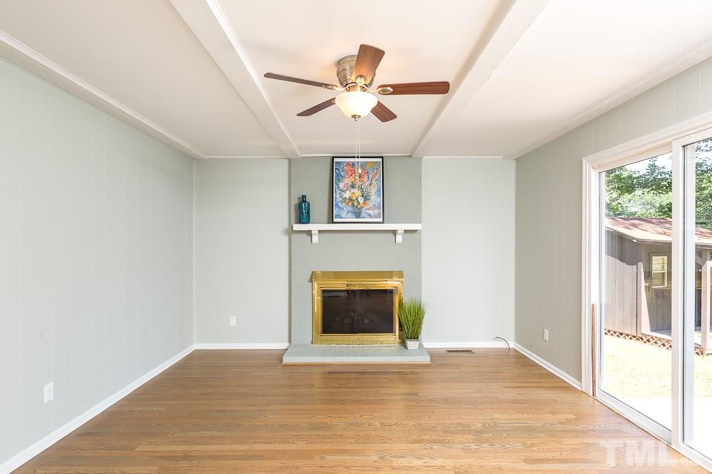 400 Old Farm Road Raleigh, NC 27606 - Photo 14 of 23 Entertain in this Family Room open to Dining Area! Welcoming fireplace and beamed ceiling. New hardwood floors. Walls and fireplace freshly painted, new fan and new energy efficient sliding glass door allowing lots of natural light.