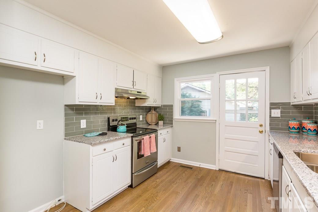 400 Old Farm Road Raleigh, NC 27606 - Photo 8 of 23 Freshly painted cabinets, new granite counter tops with double bull-nose edge, new double-bowl stainless sink, new Lighting, new stainless appliances, new glass subway tile back splash and new site-laid hardwood floors
