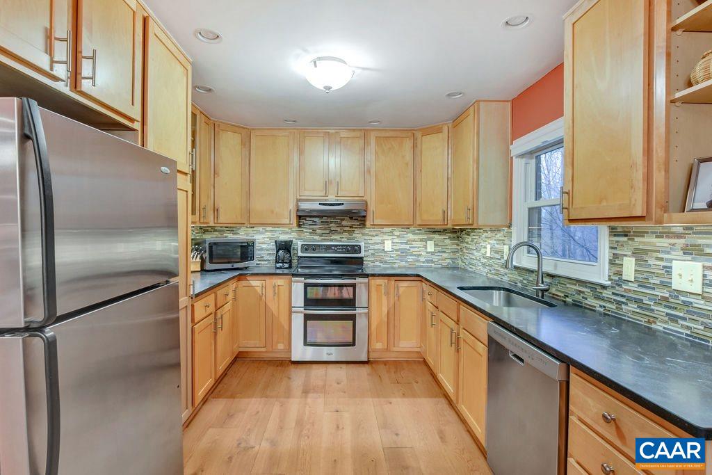 2421 Huntington Road Charlottesville, VA 22901 - Photo 12 of 40 a kitchen with stainless steel appliances granite countertop a refrigerator a sink dishwasher a stove with wooden cabinets and floor