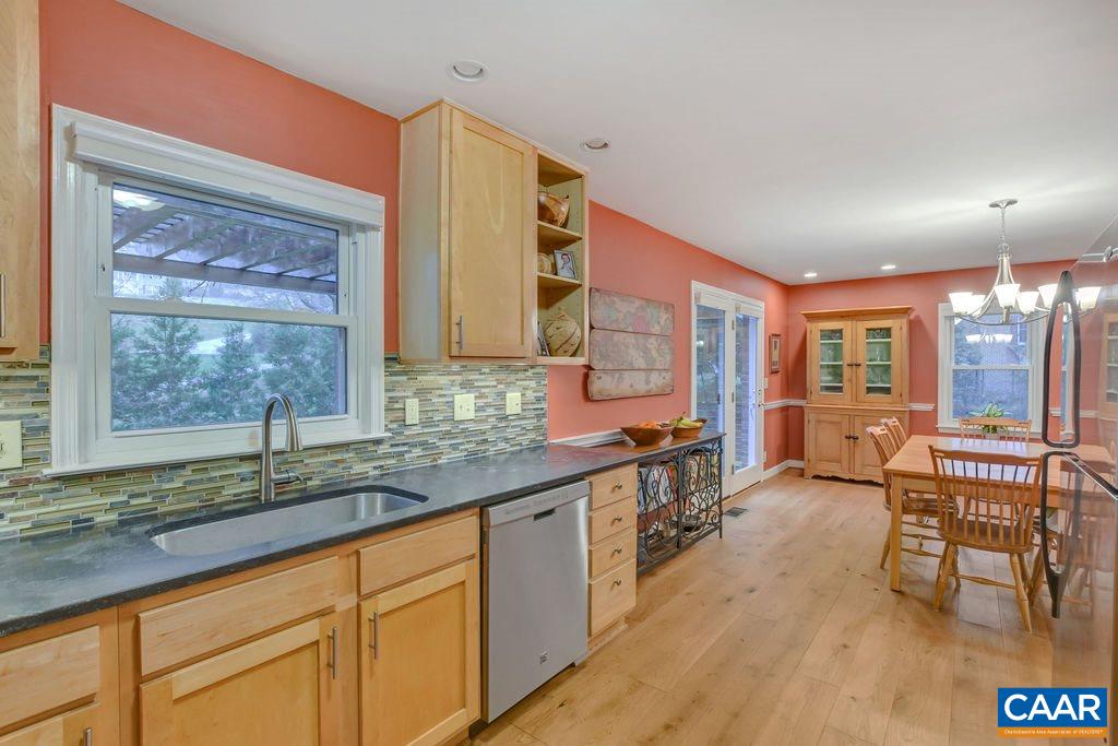 2421 Huntington Road Charlottesville, VA 22901 - Photo 15 of 40 a large kitchen with kitchen island granite countertop a large window and stainless steel appliances
