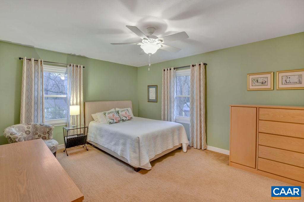 2421 Huntington Road Charlottesville, VA 22901 - Photo 18 of 40 a bedroom with a large bed and a chandelier