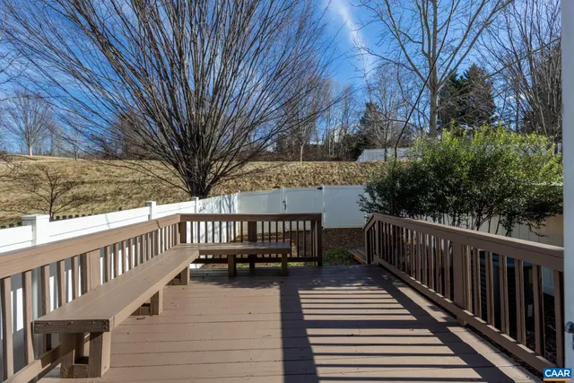 a view of balcony with wooden floor and fence