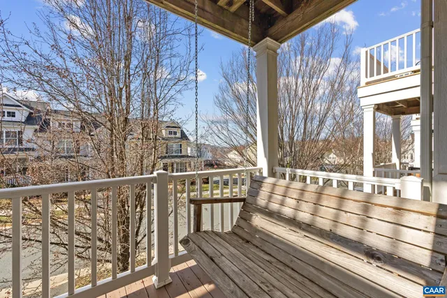 a view of a balcony with wooden floor and fence