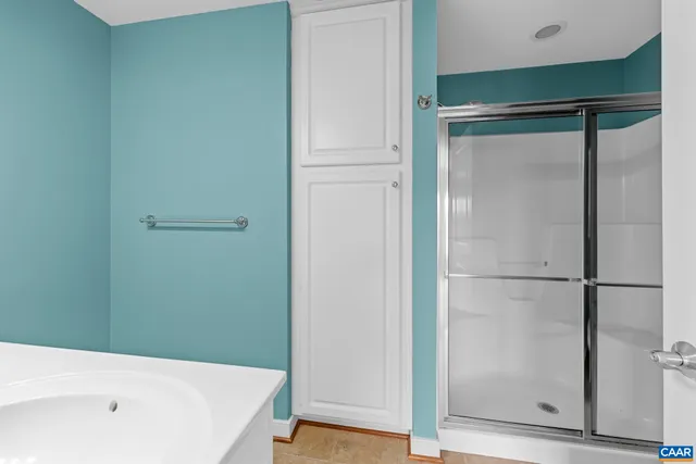 a bathroom with a bathtub and a shower