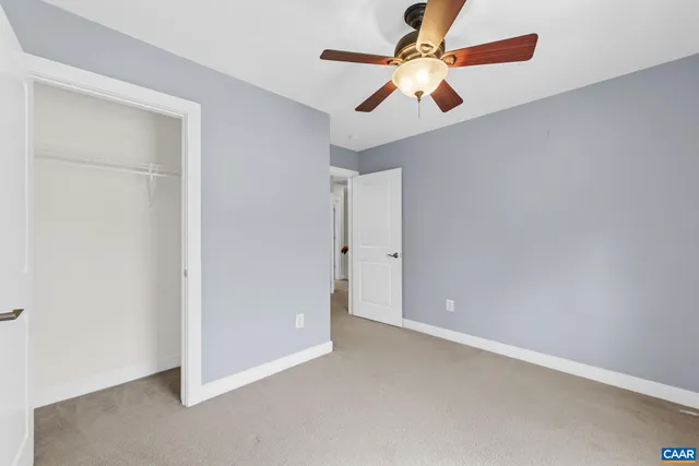 an empty room with chandelier fan