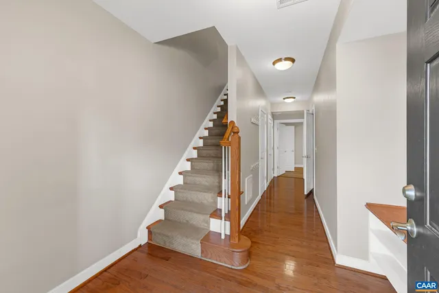 a view of entryway and hall with wooden floor