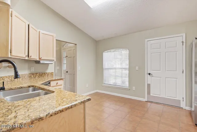 a kitchen with stainless steel appliances granite countertop a sink stove and cabinets