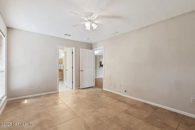 a view of an empty room with a ceiling fan