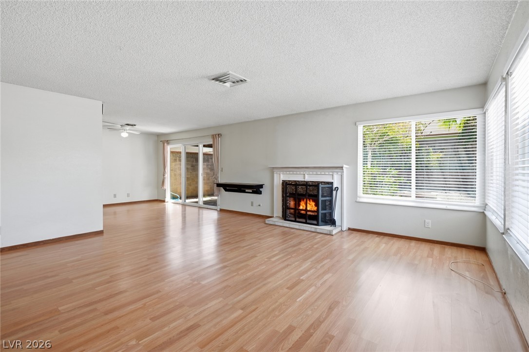 3971 Spring Leaf Drive Las Vegas, NV 89147 - Photo 27 of 48 Bright hardwood floors and a warm fireplace invite comfortable living.