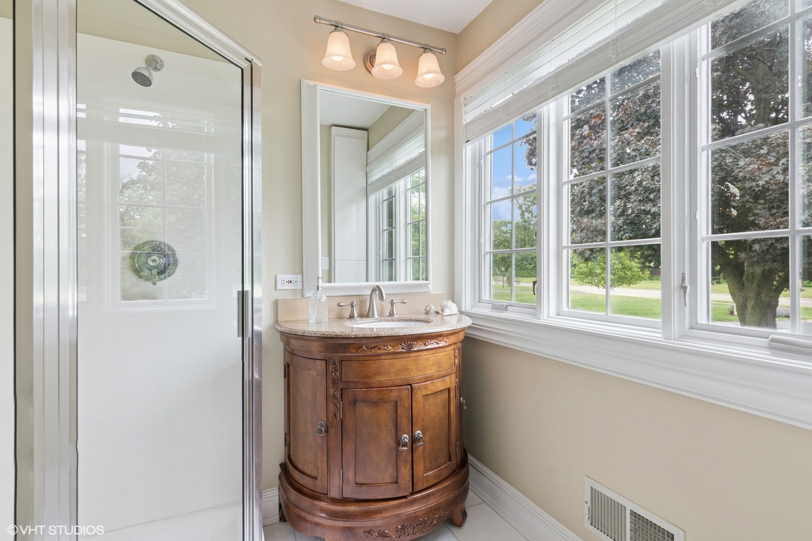 6730 South Madison Street Willowbrook, IL 60527 - Photo 29 of 52 a bathroom with a granite countertop sink a mirror and a shower