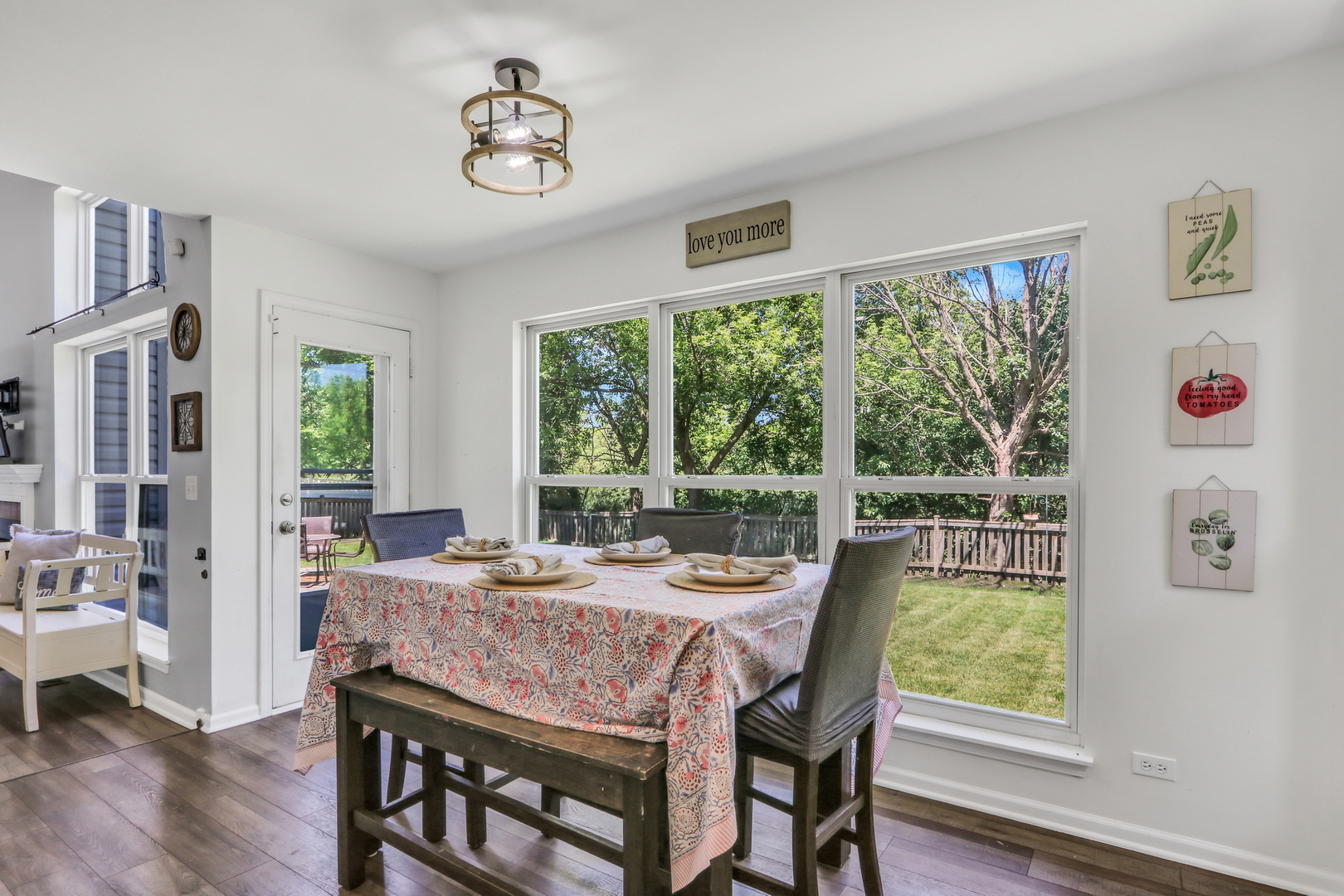 32 Highland Road Grayslake, IL 60030 - Photo 12 of 39 a dining room with wooden floor a chandelier a glass table and windows