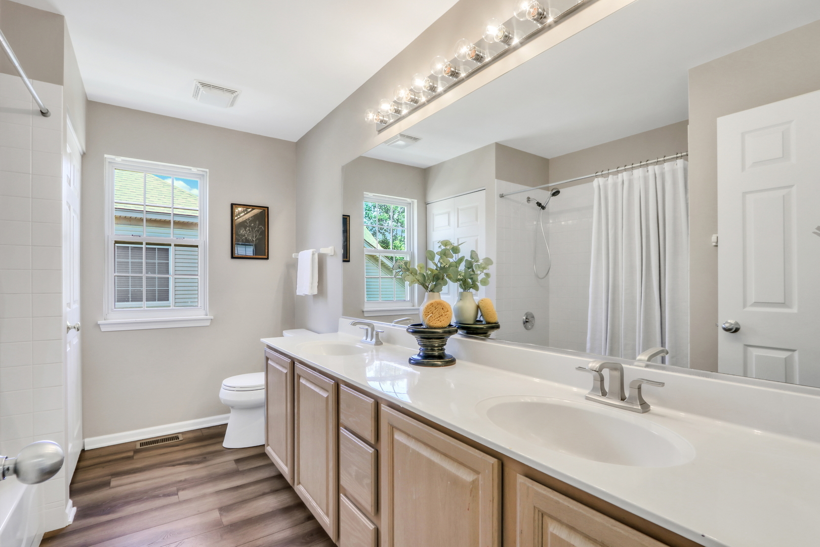 32 Highland Road Grayslake, IL 60030 - Photo 27 of 39 a bathroom with a double vanity sink a toilet and a window