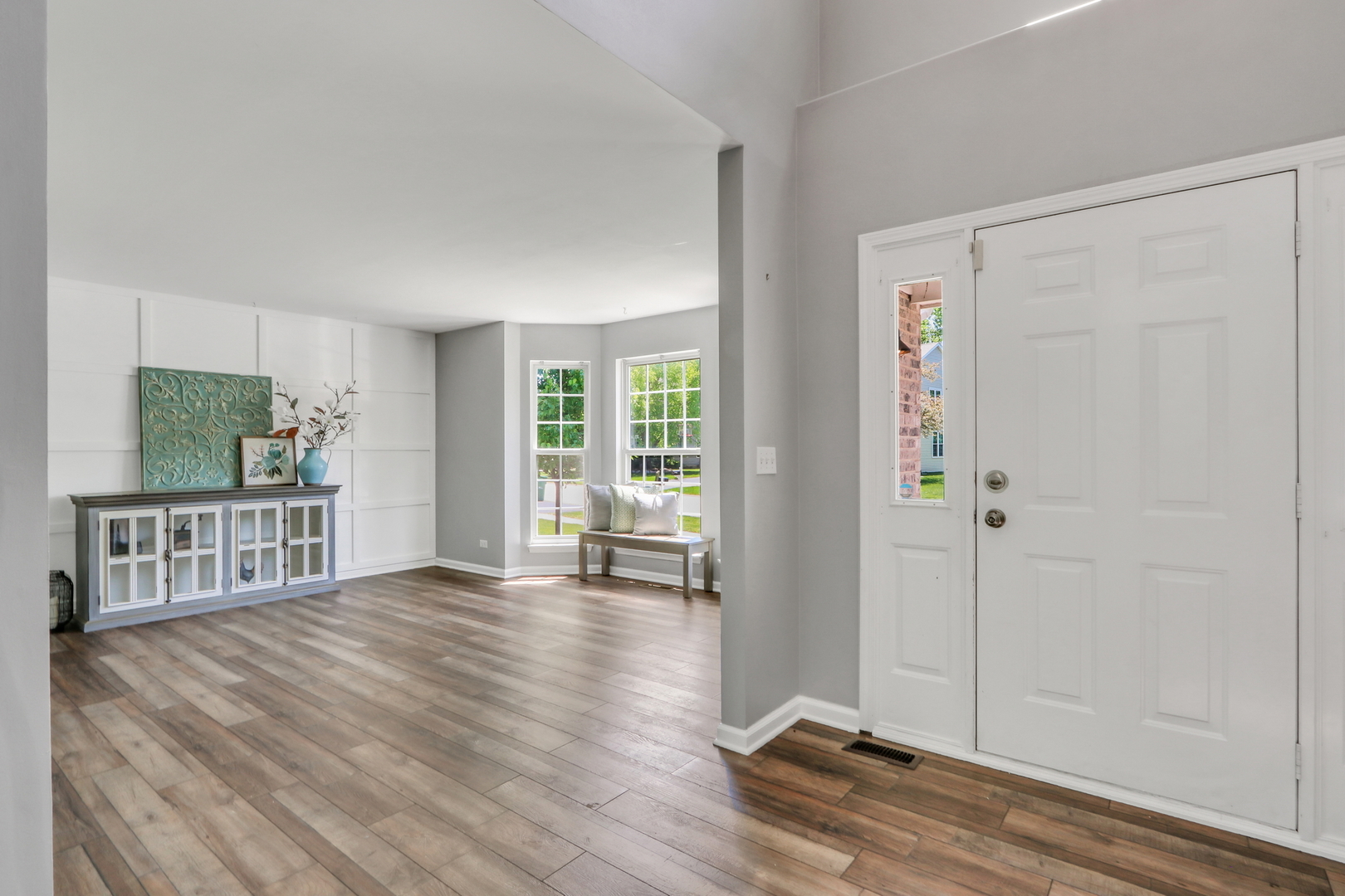 32 Highland Road Grayslake, IL 60030 - Photo 3 of 39 a view of an empty room with wooden floor and a window