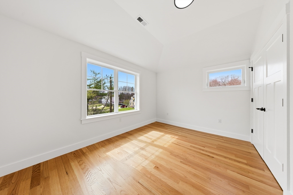2 Old County Road, Unit 14 Salisbury, MA 01952 - Photo 17 of 33 a view of an empty room with window and wooden floor