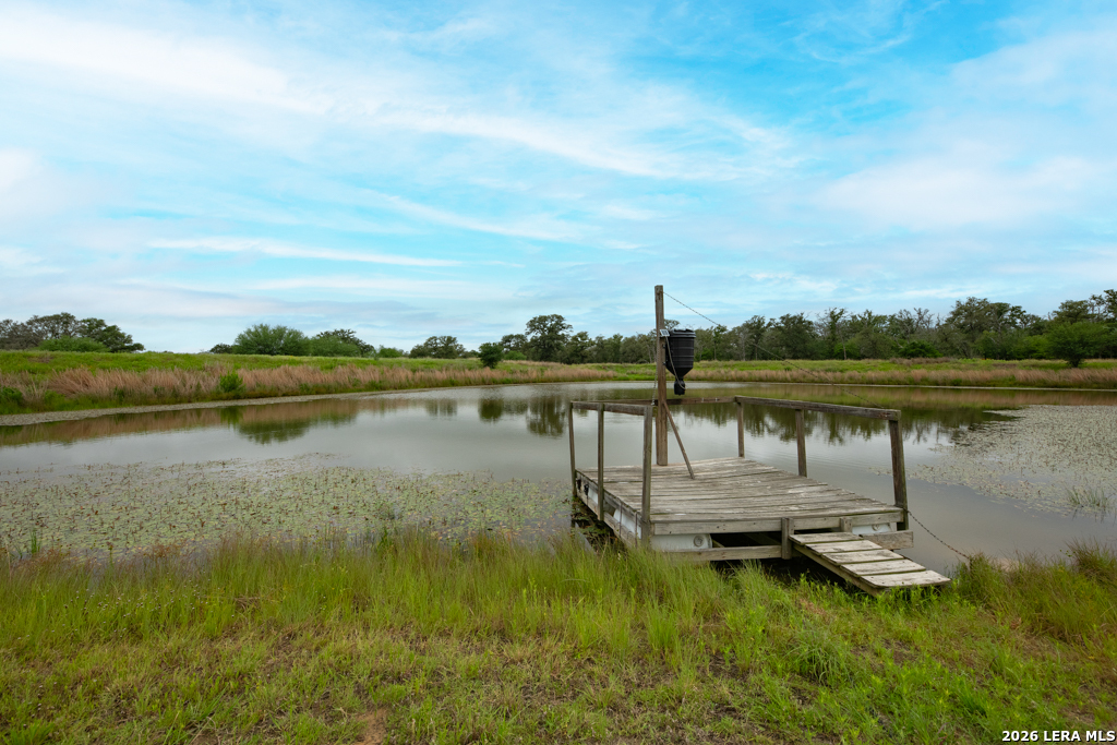 104 Longhorn Road Stockdale, TX 78160 - Photo 19 of 47 a view of a lake with houses in the back