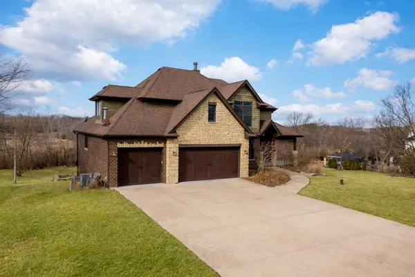 a front view of a house with a yard garage and outdoor seating