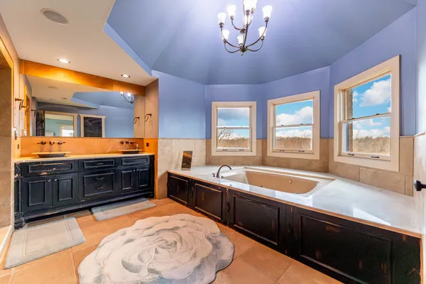 a spacious bathroom with a sink and a large mirror