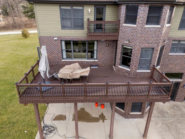 an aerial view of residential house with pool and yard