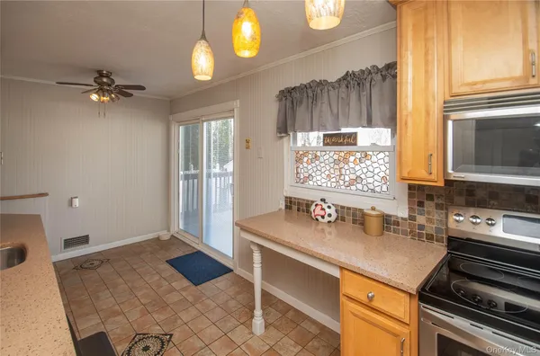 a kitchen with a sink appliances and cabinets