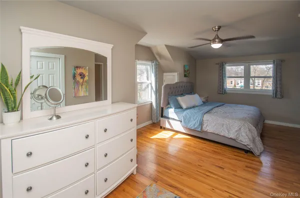 a bedroom with wooden floor and a bed