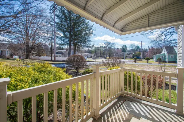 a view of a balcony with yard