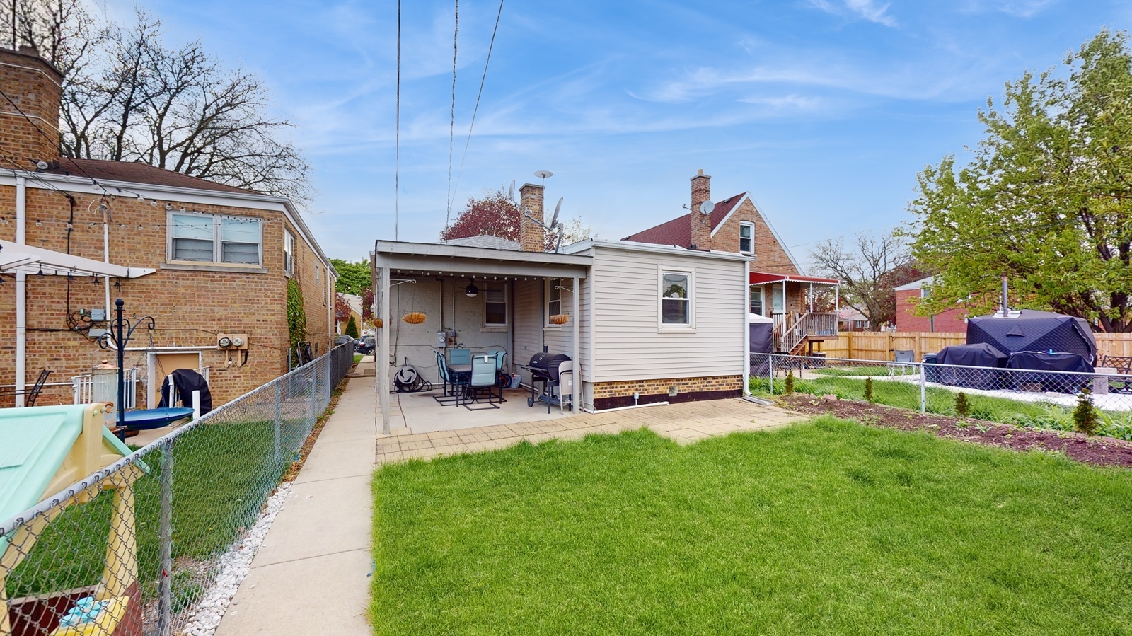 3703 South 58th Court Cicero, IL 60804 - Photo 2 of 2 a front view of a house with patio and garden