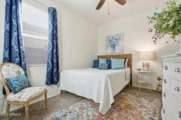 a bedroom with a bed and a chair